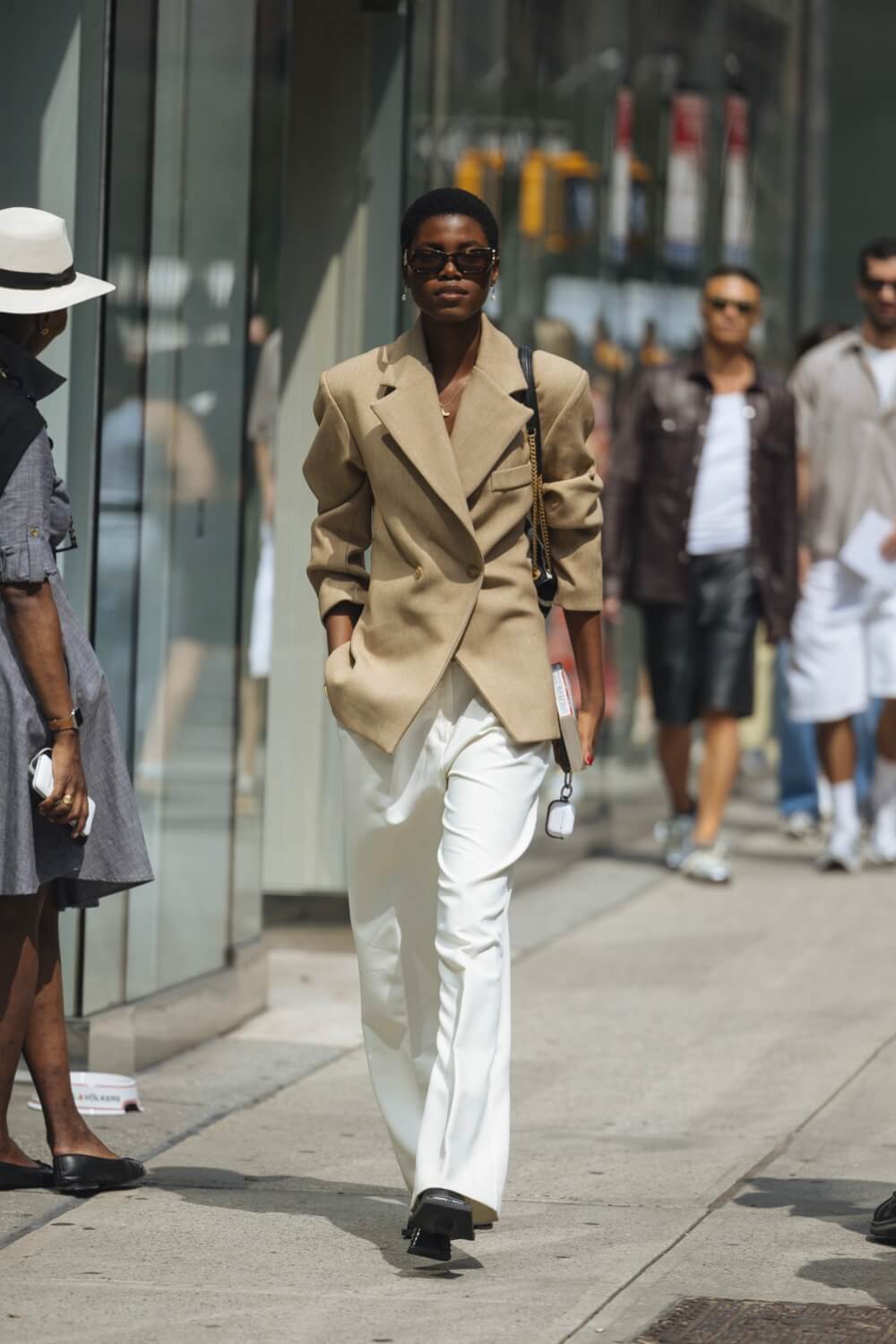 Woman wearing a tan blazer with white pants at New York Fashion Week