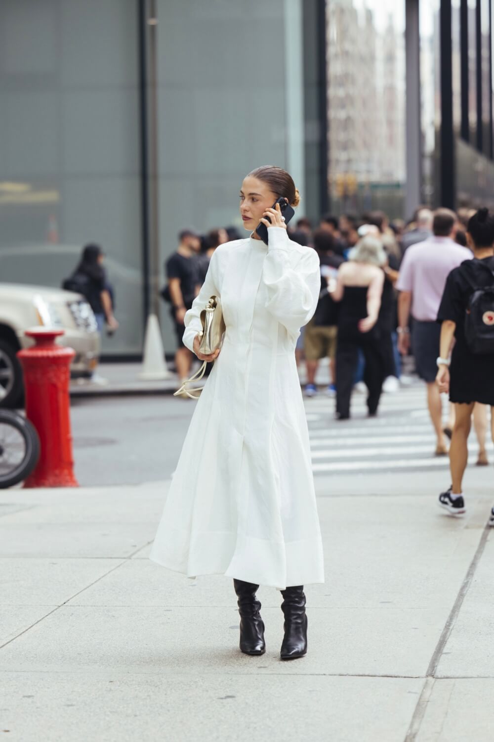 Woman wearing long sleeve white cotton dress with black boots