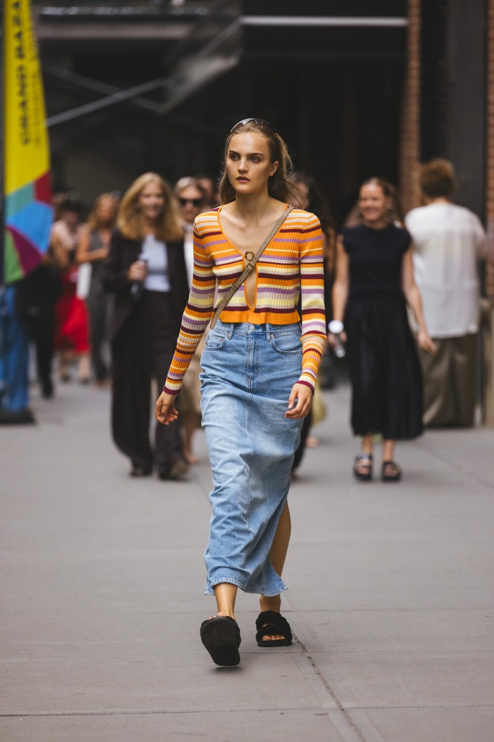 Girl wearing striped cardigan and denim midi skirt