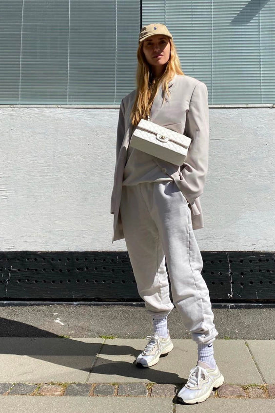 Pernille Teisbaek wearing a cream sweatpants and sweatshirt with blazer and sneakers
